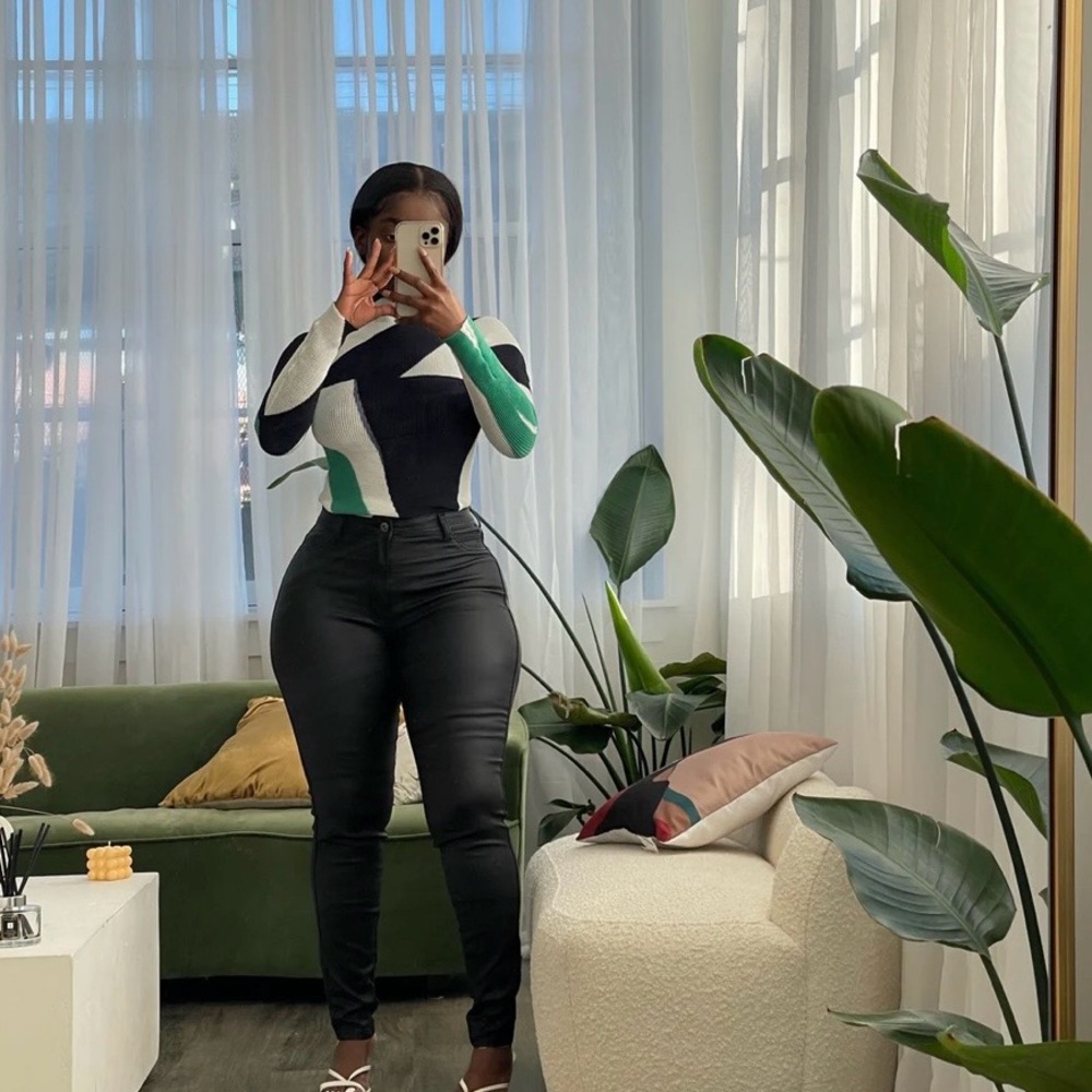 Stylish Black and White Sweater with Green Accents